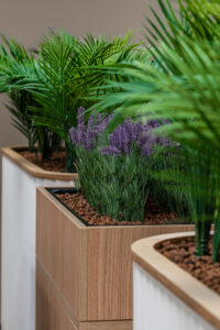 Three office planters with mix of white and purple plants